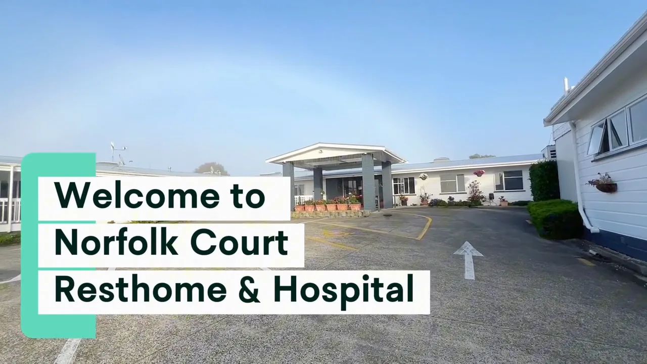 Looping exterior video of the Norfolk Court facility on a sunny day — the site's 'Watch Our Story' hero clip.